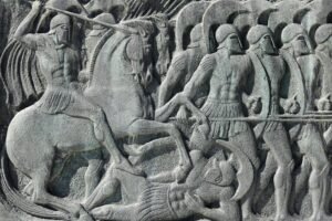 أدب Intricate stone relief depicting an ancient Greek battle scene in Thessaloniki, Greece.